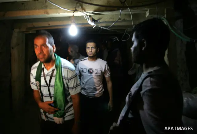 Freed Palestinian prisoners and their relatives walk through a tunnel underground the border between Egypt and southern Gaza Strip town of Rafah on Oct. 26,2011. Prisoners released to the Gaza Strip in a dramatic swap fo...