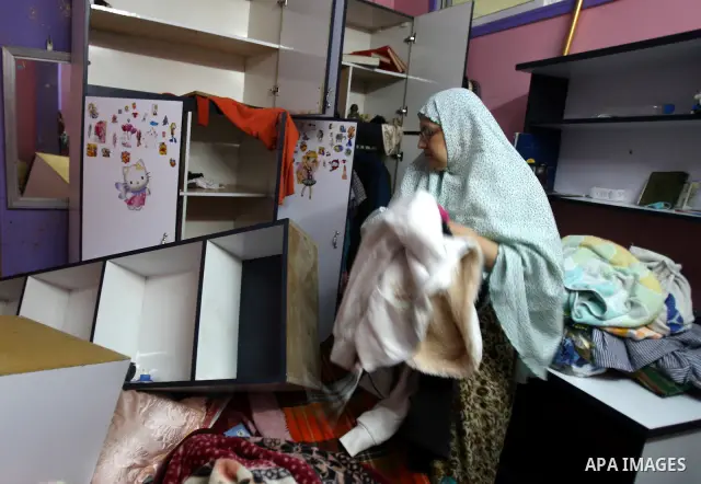 Palestinians inspect a damage room of their home in the Balata Refugee Camp in the West Bank City of Nablus, on 27 October 2011. Homes at the camp were apparently damaged during an Israeli military raid on a manhunt for...