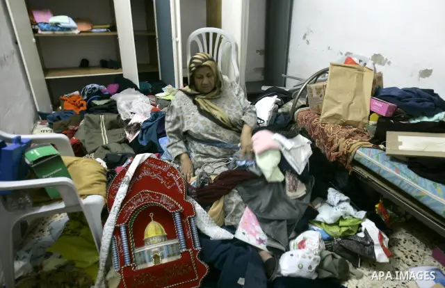 Palestinians inspect a damage room of their home in the Balata Refugee Camp in the West Bank City of Nablus, on 27 October 2011. Homes at the camp were apparently damaged during an Israeli military raid on a manhunt for...