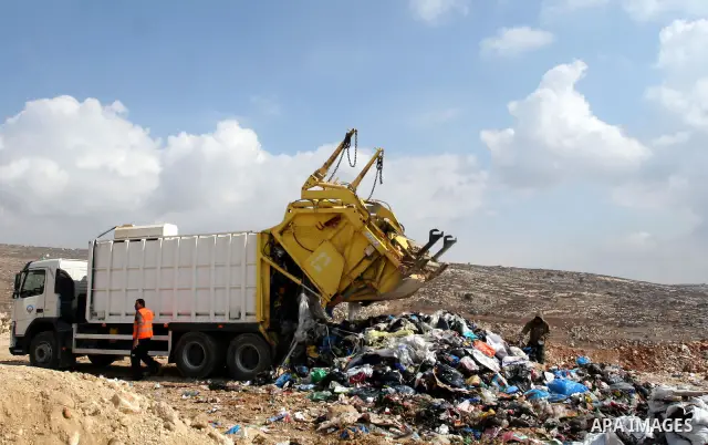 Palestinians sift through garbage that was dumped near Ramallah, in the West Bank, 27 October 2011. Palestinians regularly sift through the garbage looking for clothes, metal and any other object thrown out by the nearby...