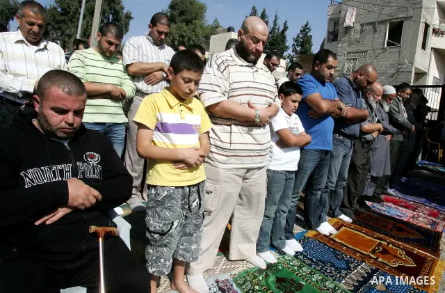 Palestinians attend Friday prayers in a tent outside the Red Cross headquarters in east Jerusalem on October 28, 2011 in solidarity with Hamas legislators who took refugee inside the ICRC building in June last year in or...