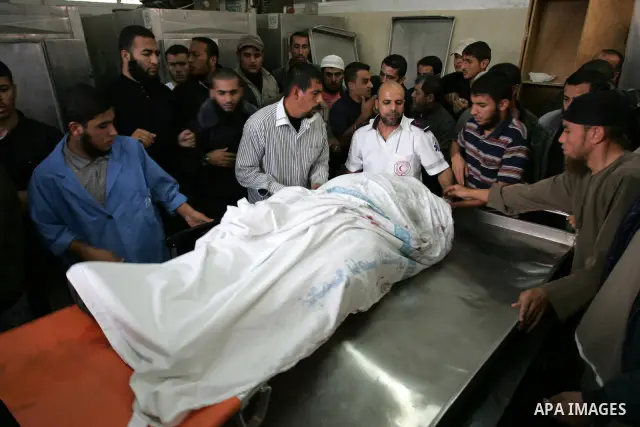 Palestinians wheel the body of a Palestinian militant of Islamic Jihad killed in an Israeli air strike into the al-Najar hospital in the southern Gaza Strip town of Rafah on October 29 2011. Six Islamic Jihad militants w...