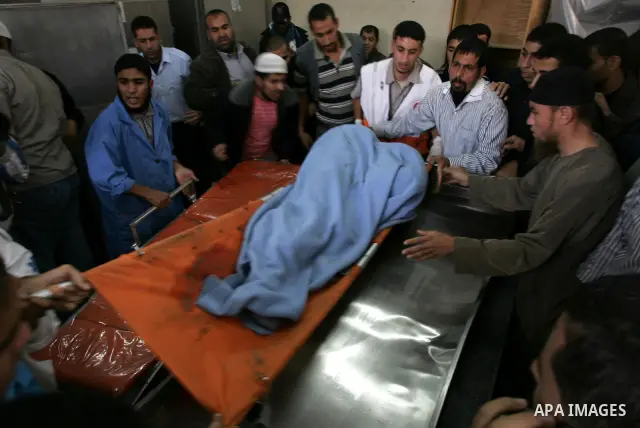 Palestinians wheel the body of a Palestinian militant of Islamic Jihad killed in an Israeli air strike into the al-Najar hospital in the southern Gaza Strip town of Rafah on October 29 2011. Six Islamic Jihad militants w...