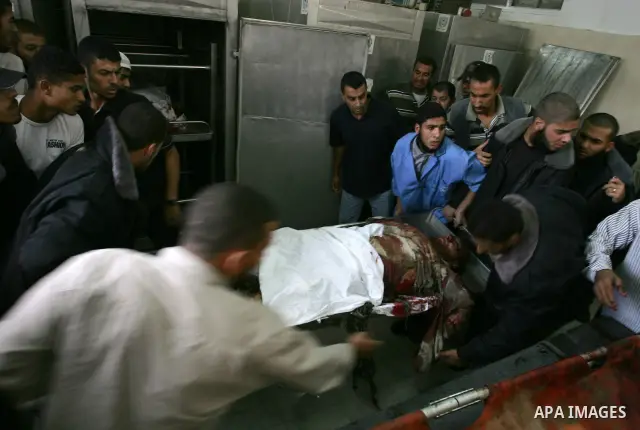 Palestinians wheel the body of a Palestinian militant of Islamic Jihad killed in an Israeli air strike into the al-Najar hospital in the southern Gaza Strip town of Rafah on October 29 2011. Six Islamic Jihad militants w...