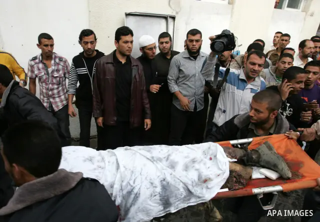 Palestinians wheel the body of a Palestinian militant of Islamic Jihad killed in an Israeli air strike into the al-Najar hospital in the southern Gaza Strip town of Rafah on October 29 2011. Six Islamic Jihad militants w...