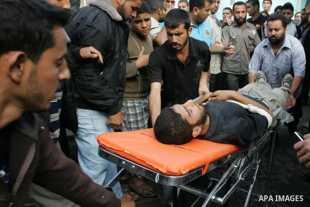 Palestinians wheel the body of a Palestinian militant of Islamic Jihad killed in an Israeli air strike into the al-Najar hospital in the southern Gaza Strip town of Rafah on October 29 2011. Six Islamic Jihad militants w...