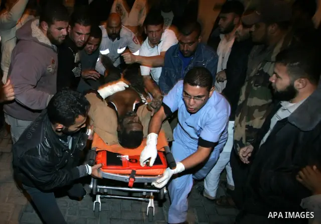 Medics treat a wounded Palestinian militant at Al Najar hospital following an Israeli air strike in Rafah, southern Gaza Strip, Saturday, Oct. 29, 2011. Israeli air craft struck at Palestinian militants in Gaza on Saturd...
