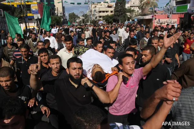 Palestinian mourners shout slogans during the funerals of militants of the Islamic Jihad movement in Gaza City on Oct. 30, 2011, killed during Israeli air raids late last night. The Islamic Jihad said it would observe an...