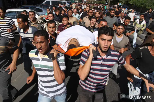 Palestinian mourners shout slogans during the funerals of militants of the Islamic Jihad movement in Gaza City on Oct. 30, 2011, killed during Israeli air raids late last night. The Islamic Jihad said it would observe an...