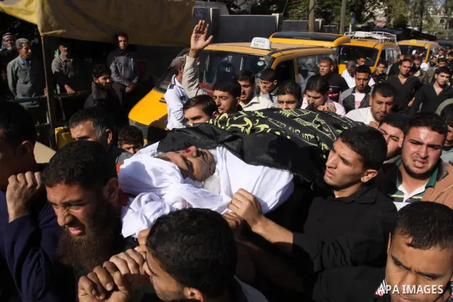 Palestinian mourners shout slogans during the funerals of militants of the Islamic Jihad movement in Gaza City on Oct. 30, 2011, killed during Israeli air raids late last night. The Islamic Jihad said it would observe an...