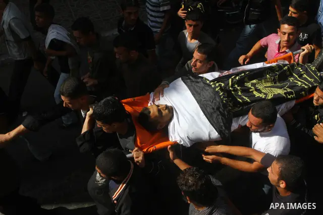 Palestinian mourners take part in the funerals of militants of the Islamic Jihad movement in Gaza City on Oct. 30, 2011, killed during Israeli air raids late last night. The Islamic Jihad said it would observe an Egyptia...