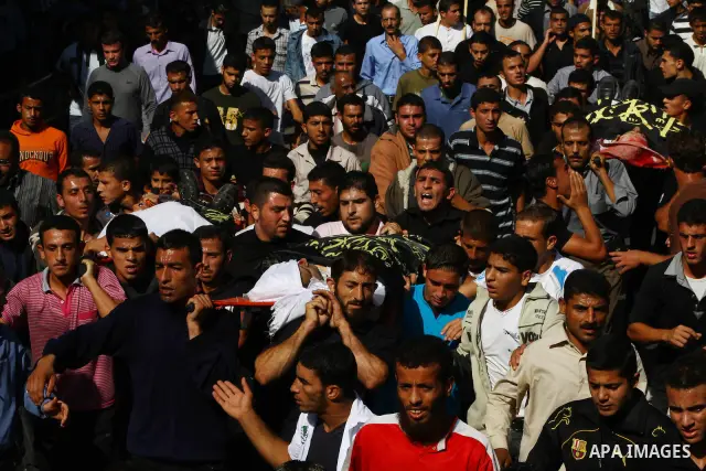 Palestinian mourners take part in the funerals of militants of the Islamic Jihad movement in Gaza City on Oct. 30, 2011, killed during Israeli air raids late last night. The Islamic Jihad said it would observe an Egyptia...
