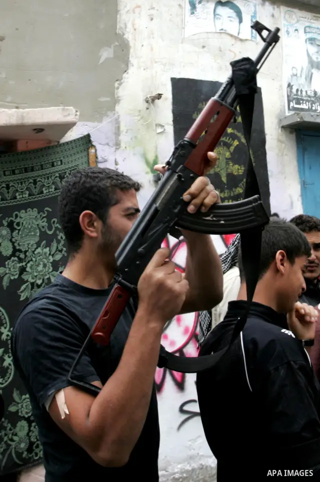 Palestinians carry the body of local Islamic Jihad militant leader Ahmed Sheikh Khalil and two other militants during their funeral in Rafah, southern Gaza Strip, Sunday, Oct. 30, 2011. Nine militants and an Israeli civi...