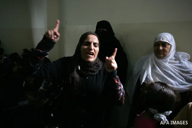 Relatives of Palestinian commander Ahmed al-Sheikh Khalil of the Islamic Jihad movement mourn during his funeral at Rafah town in the southern Gaza Strip on October 30, 2011, killed during Israeli air raids late last nig...