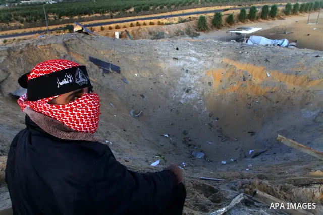 Palestinians survey a militant training base damaged in an Israeli air strike in Khan Younis in the southern Gaza Strip October 30, 2011. An Egyptian-brokered truce failed to take effect as planned on Sunday to halt a fl...