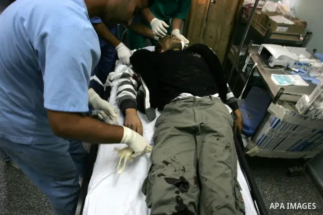 Palestinian medics checks the body Ahmed Jarghun, a militant with the armed wing of the Democratic Front for the Liberation of Palestine (DFLP), into the al-Najar hospital in Rafah on October 30, 2011 after he was killed...