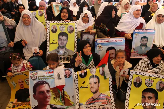 Palestinians gather during a protest at the Red Cross' offices in Gaza City to call for the release of Palestinian prisoners held in Israeli jails, on Oct. 31, 2011. An Egyptian-brokered truce appeared to be taking hold...