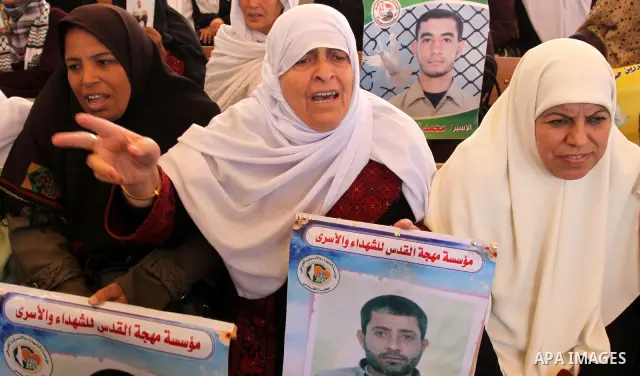 Palestinians gather during a protest at the Red Cross' offices in Gaza City to call for the release of Palestinian prisoners held in Israeli jails, on Oct. 31, 2011. An Egyptian-brokered truce appeared to be taking hold...