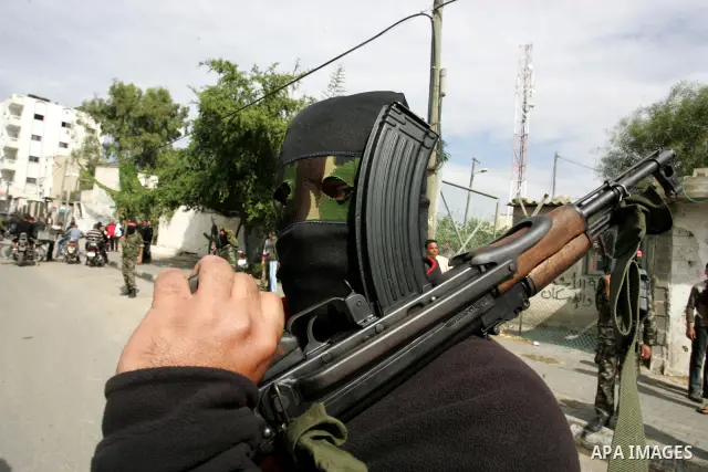 A Palestinian Democratic Front for the Liberation of Palestine militant shoots in the air during the funeral of DFLP militant Ahmed Jargon, killed in an Israeli strike on Sunday, in Rafah, southern Gaza Strip, Monday, Oc...