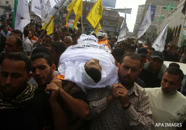 Palestinians mourn the body of Al-Ansar brigade militant Ali Alakad who was killed in an Israeli air strike early Monday, in Khan Younis, southern Gaza Strip, Monday, Oct. 31, 2011. Deadly violence between Israel and Gaz...