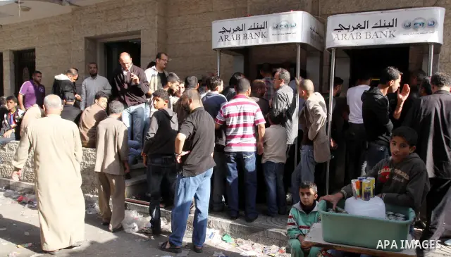 Palestinian Authority civil servants gather outside the Arab Bank in Gaza city on Nov. 03,2011, to withdraw their monthly salaries. Photo by Mohammed Asad