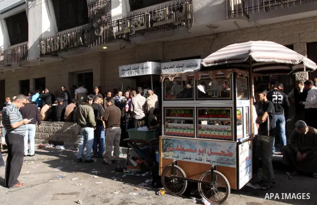 A Palestinian Displays of Goods in front of Arab Bank in Gaza city ,Palestinian Authority civil servants gather outside the Arab Bank in Gaza city on Nov. 03,2011. Photo by Mohammed Asad