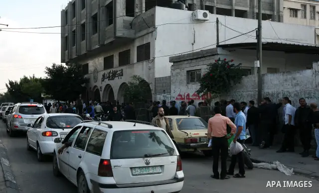Palestinian Authority civil servants gather outside the Islamic Bank in Gaza city on Nov. 03,2011, to withdraw their monthly salaries. Photo by Mahmud Nassar