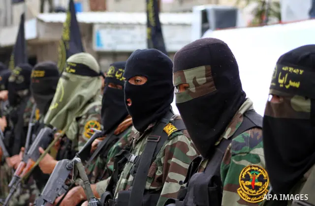 Palestinian Islamic Jihad militants and supporters take part in a rally marking the 16th anniversary of the killing of Fathi al-Shiqaqi, the militant movement's founder, in the northern Gaza Strip November 4, 2011. The m...