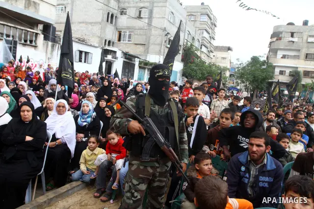 Palestinian Islamic Jihad militants and supporters take part in a rally marking the 16th anniversary of the killing of Fathi al-Shiqaqi, the militant movement's founder, in the northern Gaza Strip November 4, 2011. The m...