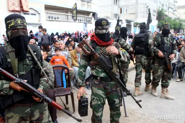 Palestinian Islamic Jihad militants and supporters take part in a rally marking the 16th anniversary of the killing of Fathi al-Shiqaqi, the militant movement's founder, in the northern Gaza Strip November 4, 2011. The m...