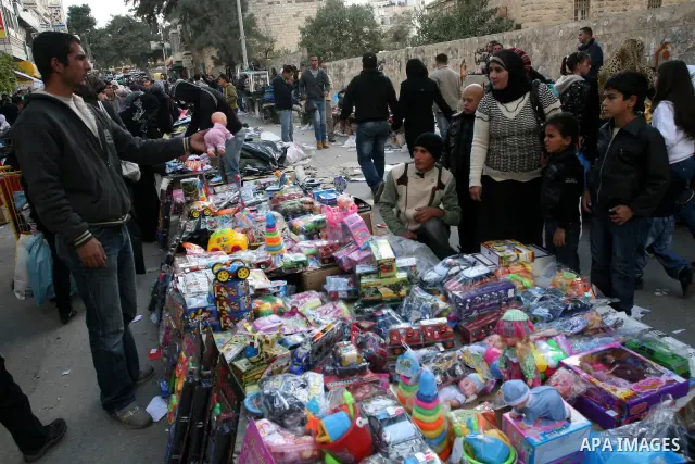 Palestinians shopping to celebrate Eid al-Adha festival in a market of Gaza City on Nov. 4, 2011. Muslims across the world are preparing to celebrate the annual festival of Eid al-Adha, or the Festival of Sacrifice. Phot...