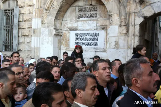 Palestinian men attend Friday prayers in front of the Al-Aqsa mosque on the compound known to Muslims as al-Haram al-Sharif, and to Jews as Temple Mount, in Jerusalem's Old city, on the first day of Eid al-Adha November...