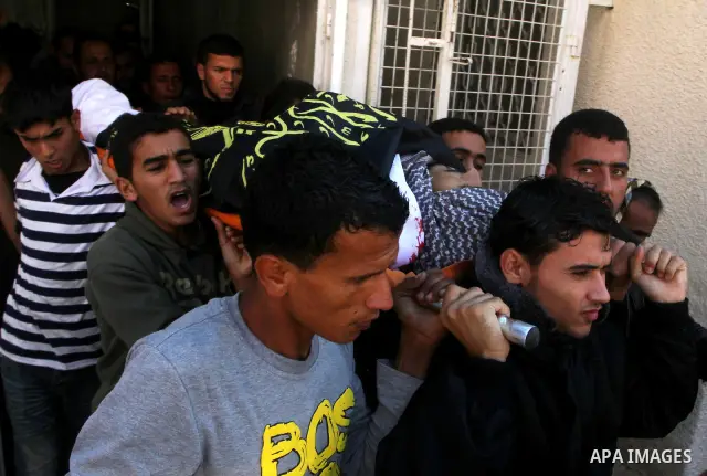 Palestinians mourn the body of Abdullah Mohana, Islamic Jihad militant, in Khan Younis, southern Gaza Strip, Sunday, Nov. 6, 2011. A Palestinian official said that one of Islamic Jihads militants was killed and several o...