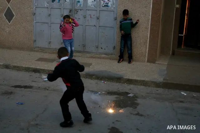 A Palestinians boys play with a toy gun in the West Bank city of Ramallah Nov.06, 2011. Muslims worldwide celebrate Eid al-Adha, or the Feast of the Sacrifice, by sacrificial killings of livestock to commemorate a religi...