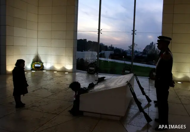 Palestinians lay flower wreathes and candles at the gravesite of late Palestinian leader Yasser Arafat on the seventh anniversary of his death in the West Bank city of Ramallah on November 11, 2011, as Palestinians gathe...