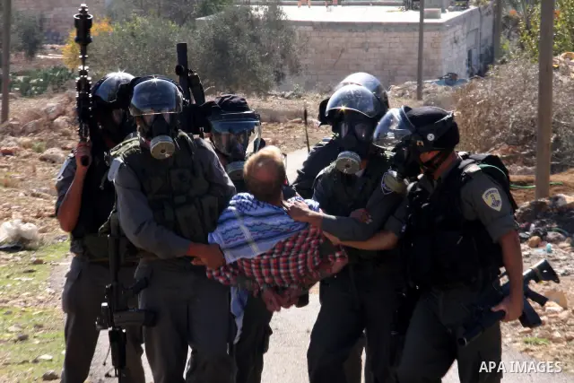 Israeli forces arrest a protestor during a weekly demonstration against Israeli-occupation in the northern West Bank village of Kfar Kadum, on November 11, 2011. The Palestinian leadership is unsure how to advance its bi...