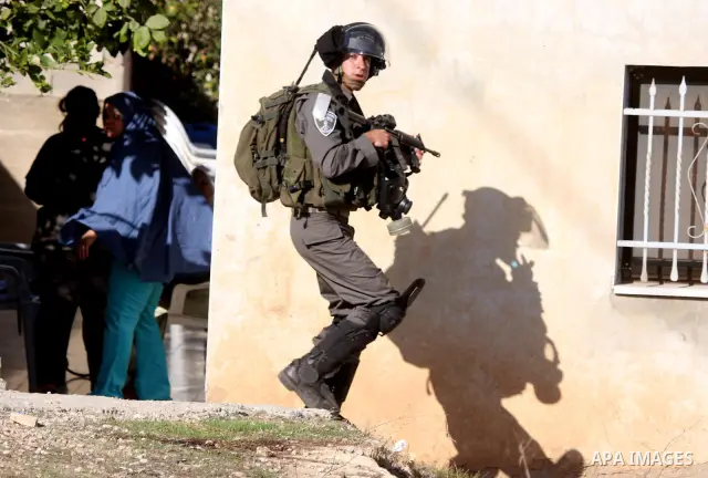 Israeli soldiers take positions during clashes between Israeli security forces and Palestinian demonstrators at a weekly protest in the West Bank village of Nabi Saleh, near Ramallah November 11, 2011.. Photo by Issam Ri...
