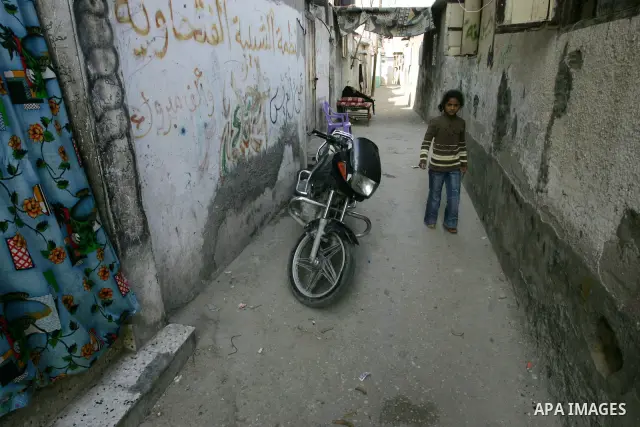 Palestinian children play outside their house in Rafah refugee camp in the southern Gaza Strip on Nov. 12, 2011. According to a member of the Executive Committee of the Palestine Liberation Organisation Saeb Erekat, ther...