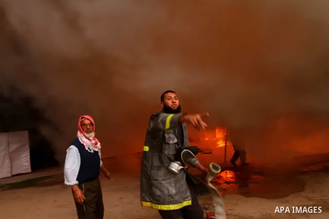 Palestinian fire fighters try to extinguish a fire at a workshop for woodwork in Gaza City November 14, 2011. The cause of the fire is unclear. Photo by Ashraf Amra