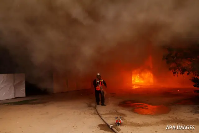 Palestinian fire fighters try to extinguish a fire at a workshop for woodwork in Gaza City November 14, 2011. The cause of the fire is unclear. Photo by Ashraf Amra