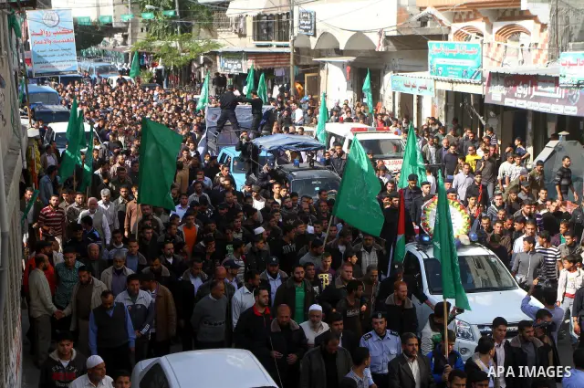 Palestinian police officers carry the body of Mohammed Al Kelani, a Hamas security officer, during his funeral in Beit Lahiya, northern Gaza Strip, Monday, Nov. 14, 2011. Al Kelani was killed in an Israeli air strike on...