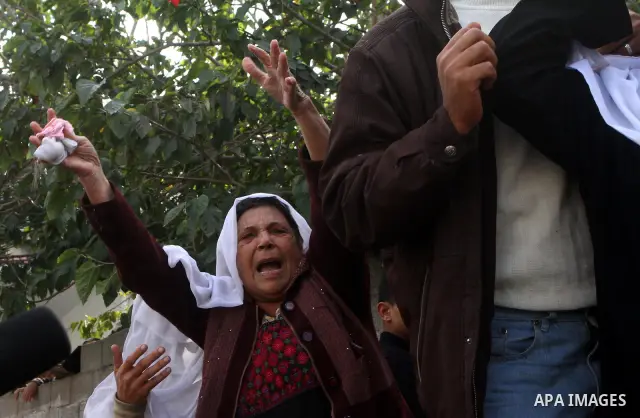Palestinians mourn the body of Mohammed Al Kelani, a Hamas security officer, during his funeral in Beit Lahiya, northern Gaza Strip, Monday, Nov. 14, 2011. Al Kelani was killed in an Israeli air strike on a Hamas naval p...