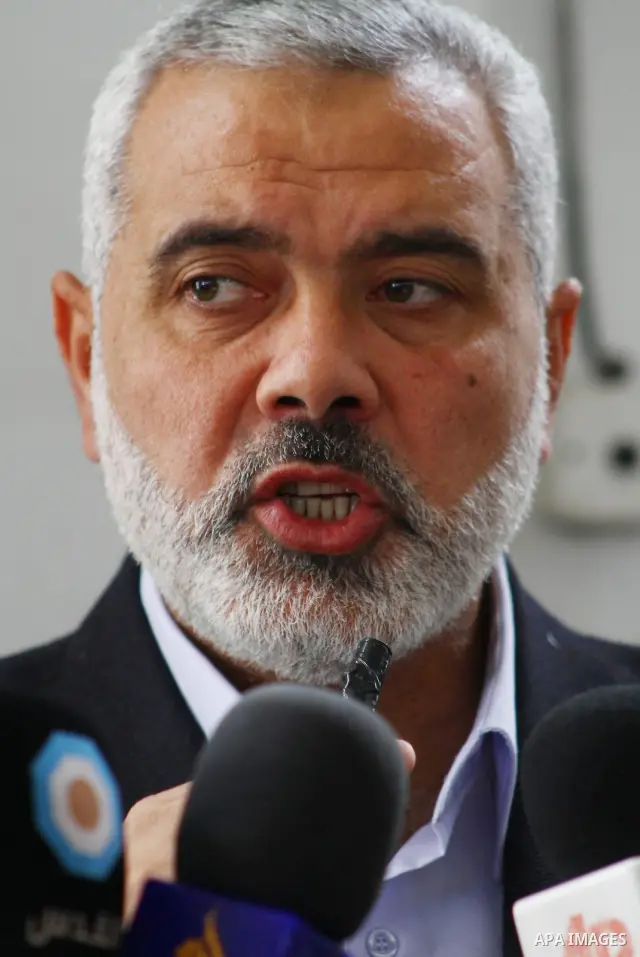 Palestinian prime minister in Gaza Strip, Ismail Haniya attends the funeral of Mohammed Al Kelani, a Hamas security officer, in Beit Lahiya, northern Gaza Strip, Monday, Nov. 14, 2011. Al Kelani was killed in an Israeli...