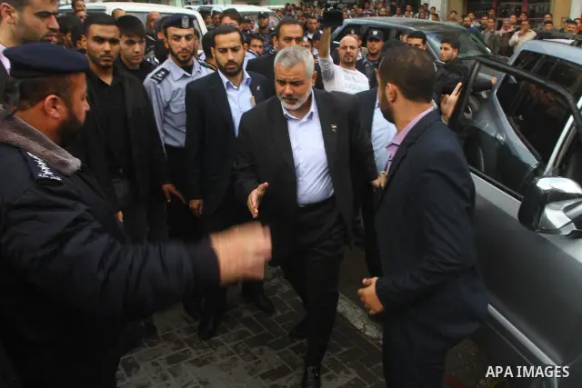 Palestinian prime minister in Gaza Strip, Ismail Haniya attends the funeral of Mohammed Al Kelani, a Hamas security officer, in Beit Lahiya, northern Gaza Strip, Monday, Nov. 14, 2011. Al Kelani was killed in an Israeli...