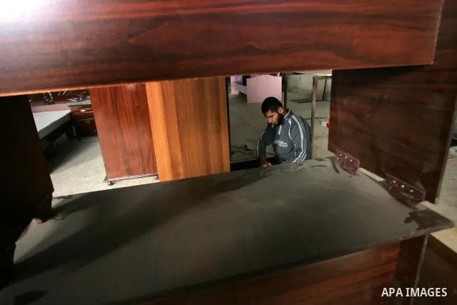 A Palestinian carpenter works at his workshop for woodwork in Rafah, southern Gaza Strip on November 14, 2011. An official in the General Federation of Palestinian Industries in Gaza Strip said on Sunday that the Israeli...
