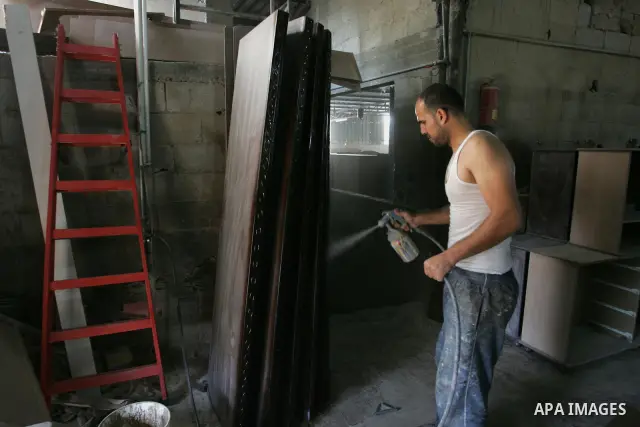 A Palestinian carpenter works at his workshop for woodwork in Rafah, southern Gaza Strip on November 14, 2011. An official in the General Federation of Palestinian Industries in Gaza Strip said on Sunday that the Israeli...