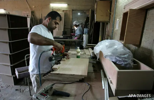 A Palestinian carpenter works at his workshop for woodwork in Rafah, southern Gaza Strip on November 14, 2011. An official in the General Federation of Palestinian Industries in Gaza Strip said on Sunday that the Israeli...