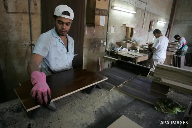 A Palestinian carpenter works at his workshop for woodwork in Rafah, southern Gaza Strip on November 14, 2011. An official in the General Federation of Palestinian Industries in Gaza Strip said on Sunday that the Israeli...