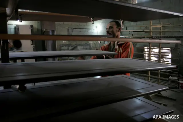 A Palestinian carpenter works at his workshop for woodwork in Rafah, southern Gaza Strip on November 14, 2011. An official in the General Federation of Palestinian Industries in Gaza Strip said on Sunday that the Israeli...