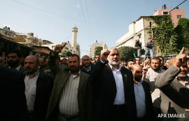 Palestinian prime minister in Gaza Strip, Ismail Haniya attends the funeral of Mohammed Al Kelani, a Hamas security officer, in Beit Lahiya, northern Gaza Strip, Monday, Nov. 14, 2011. Al Kelani was killed in an Israeli...